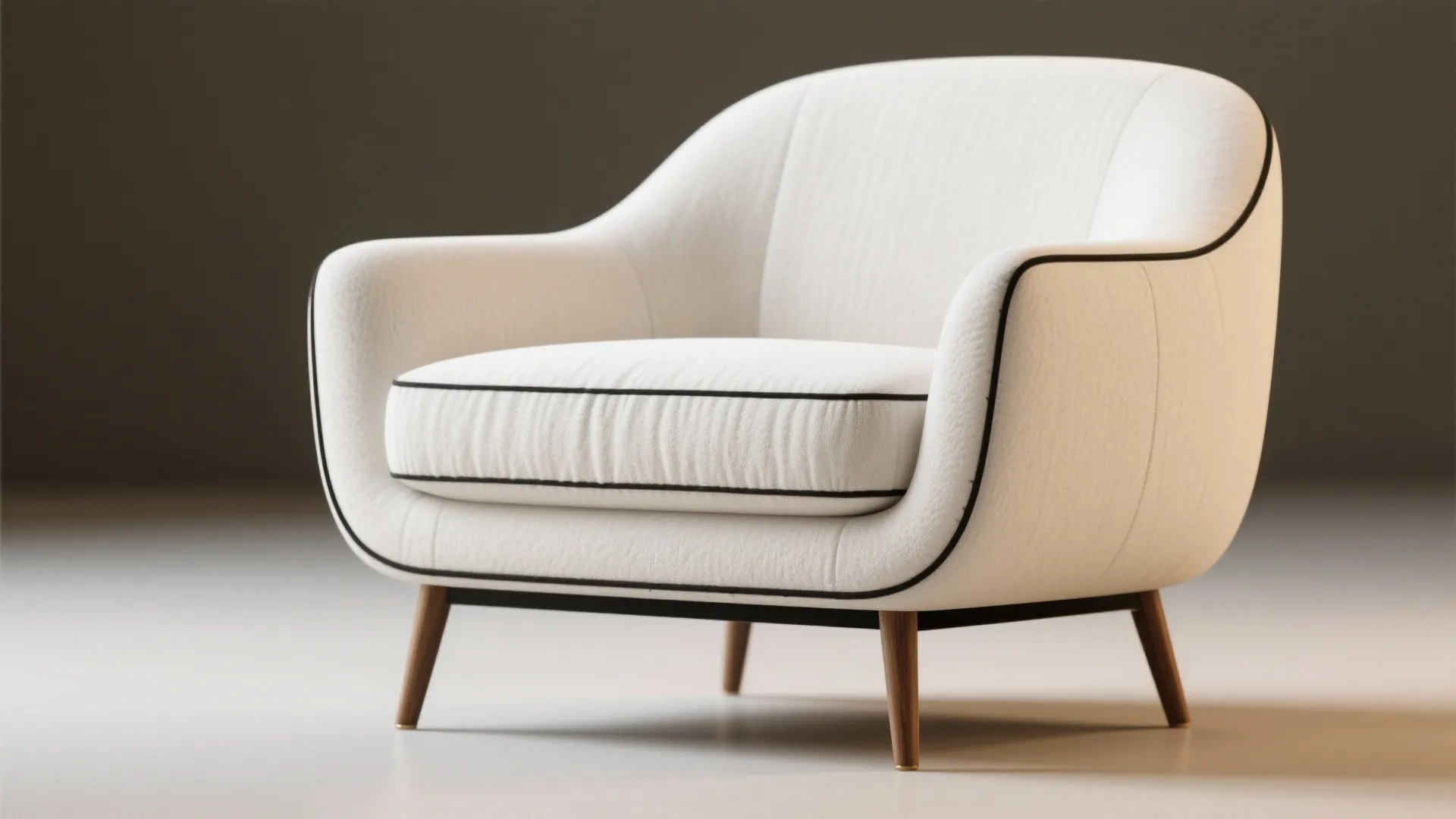 Modern white fabric sofa chair with black piping detail and wooden legs against grey wall