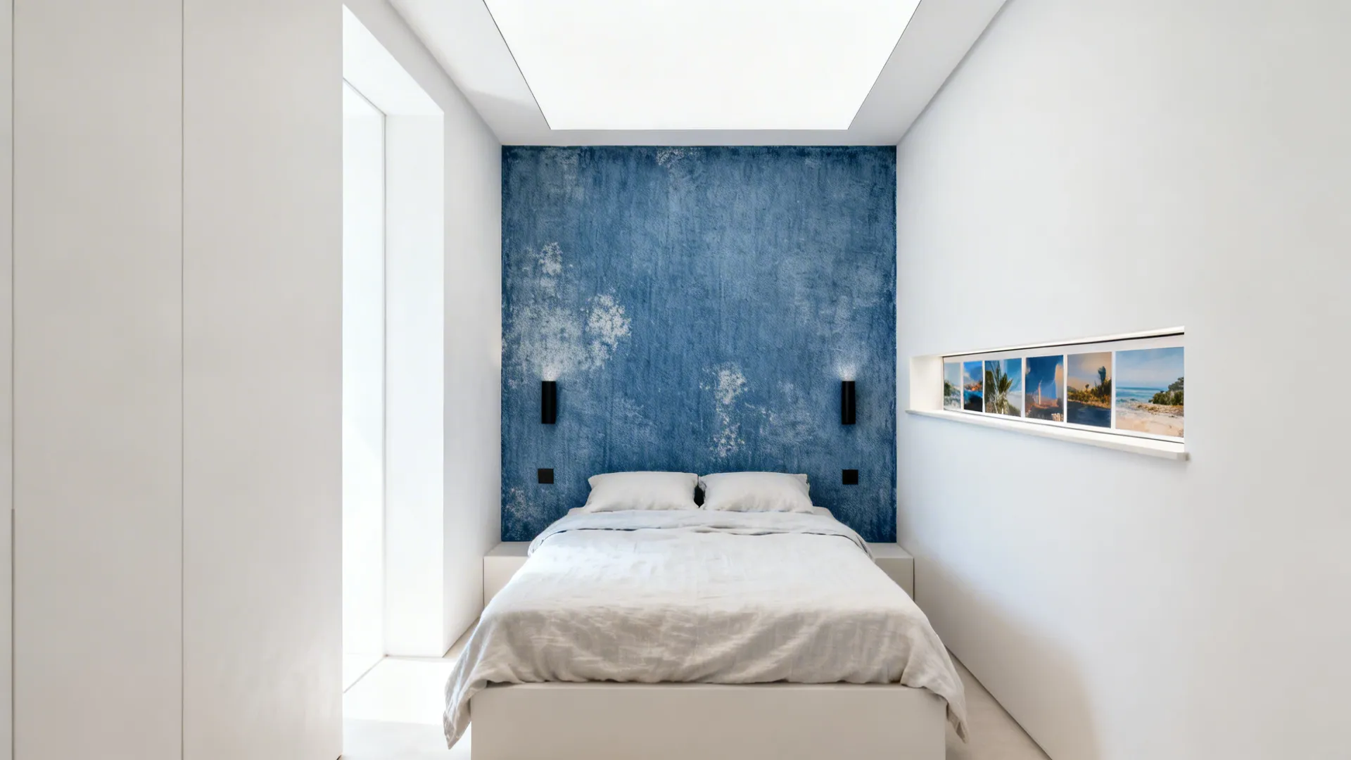 Small bedroom with off-white walls and a textured denim-blue accent behind the bed.