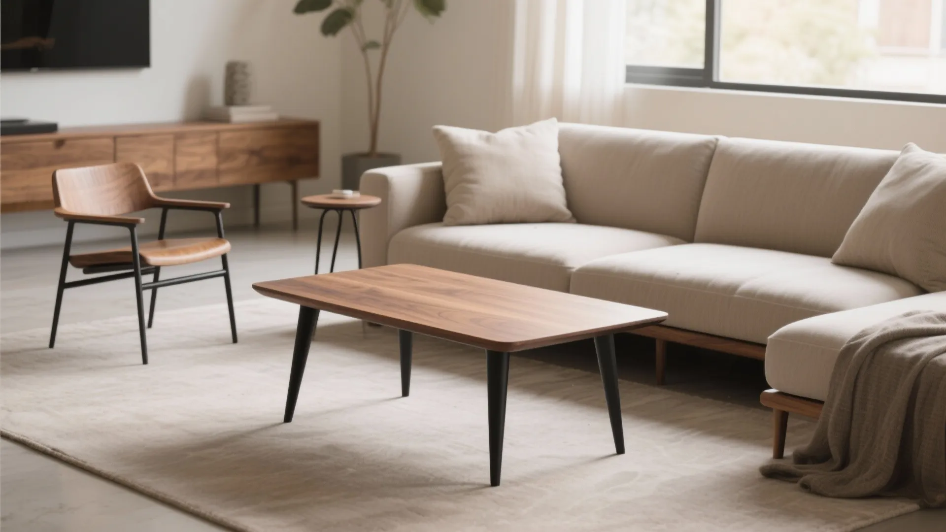 Modern living room featuring a wooden coffee table with black legs and a beige sofa