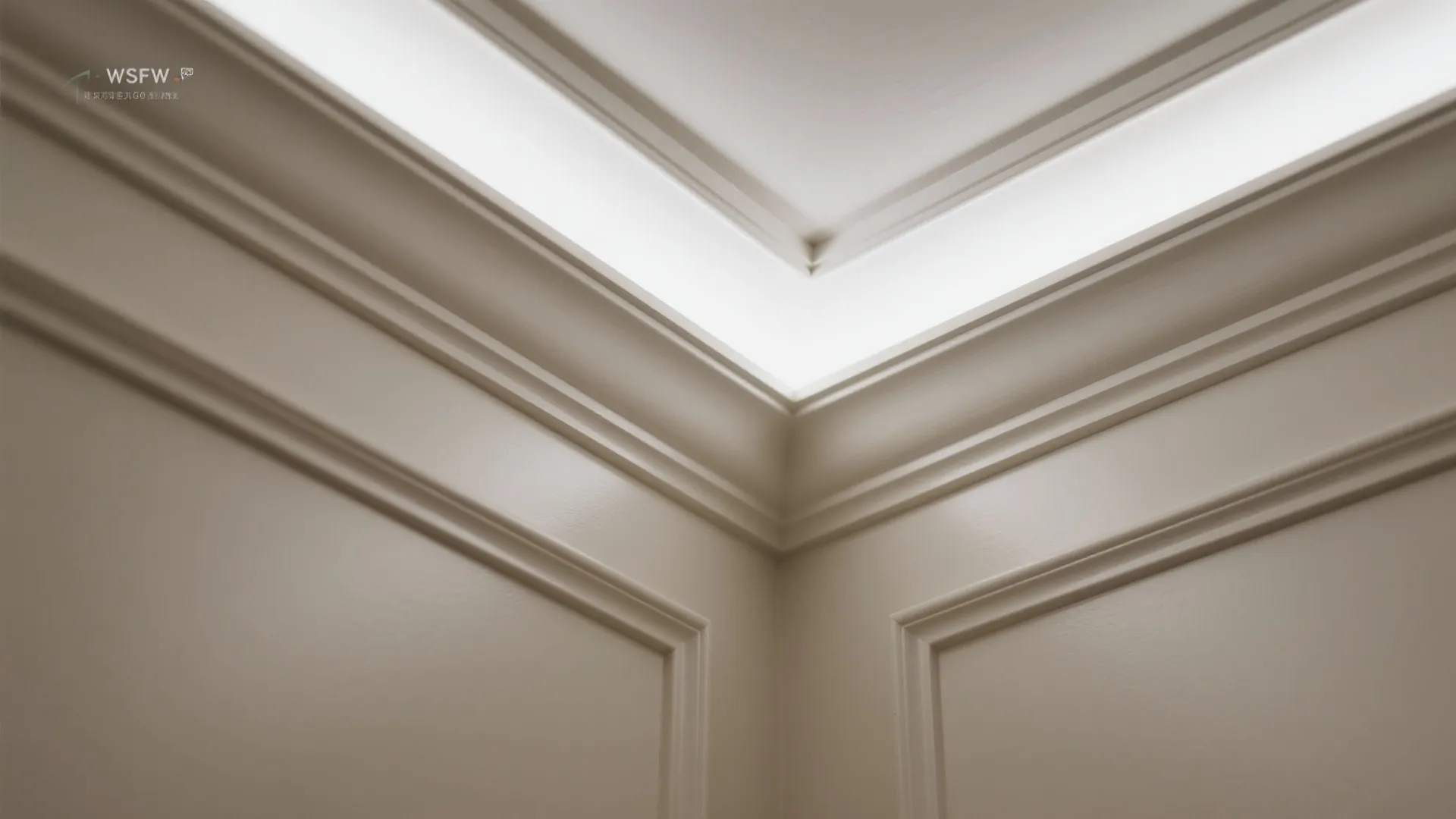 Close up view of a white ceiling corner with crown wall panel and hidden light