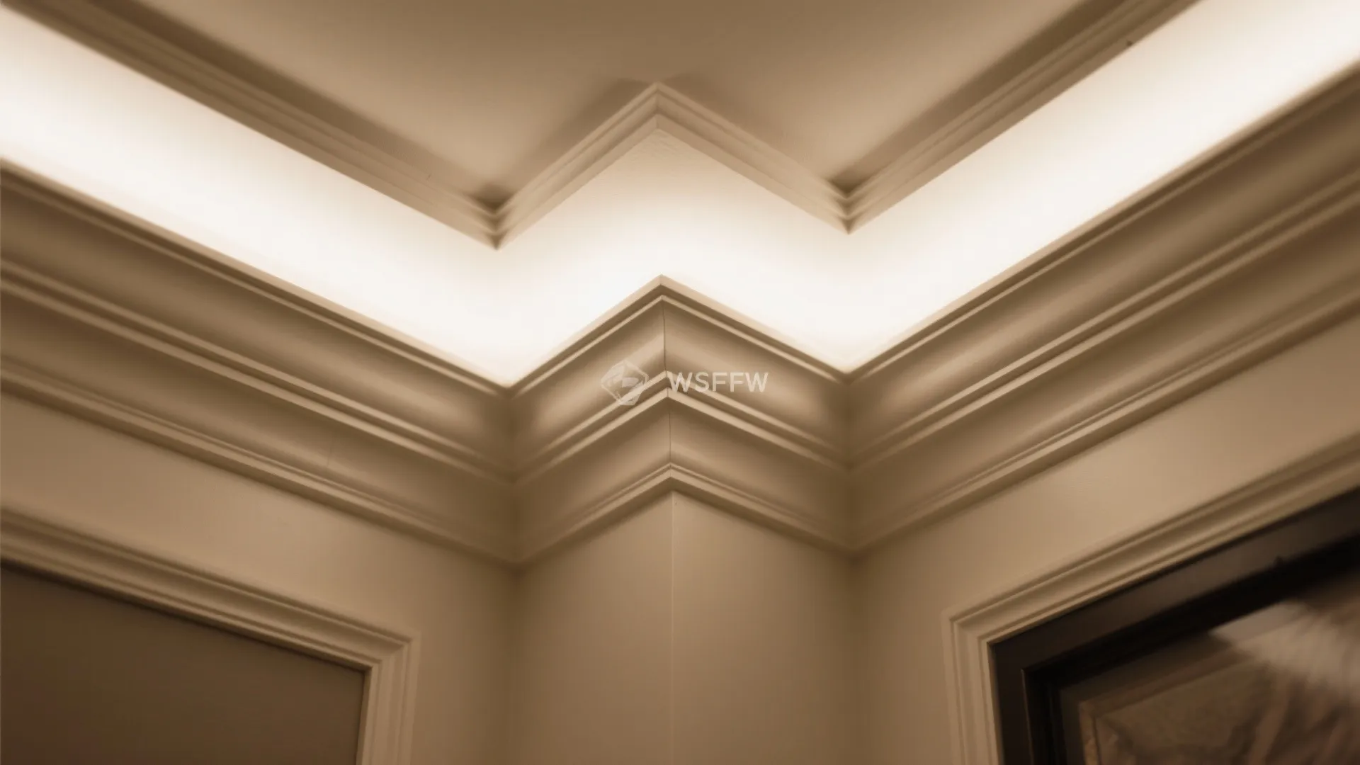 Detailed view of white ceiling corner featuring layered wall panels and integrated warm light fixtures