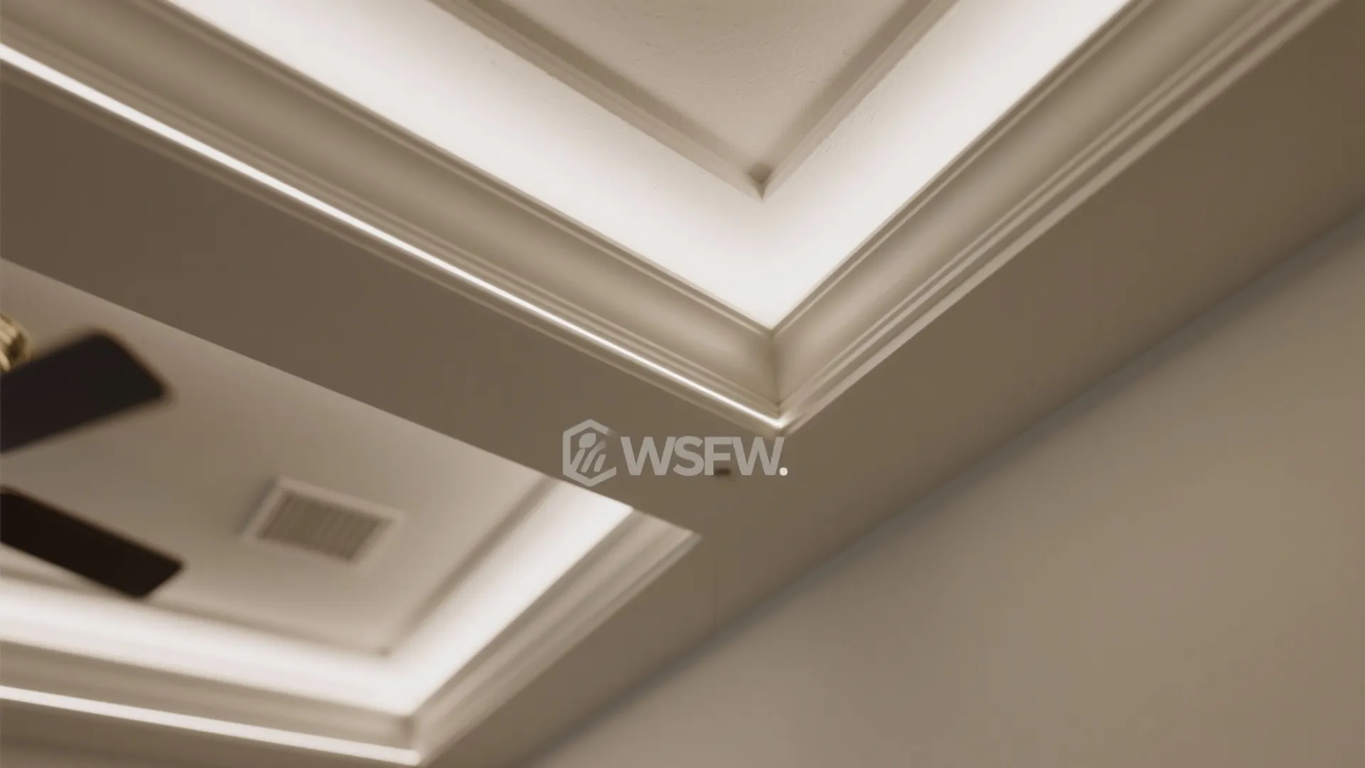 Close up of white ceiling with hidden light strips and simple elegant white ceiling trim