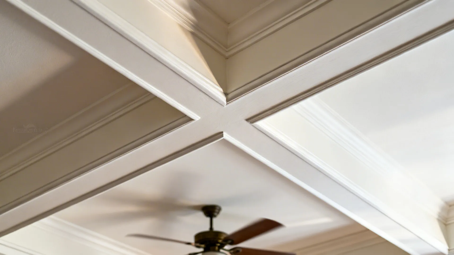 Close-up of shallow coffered ceiling reveal with painted MDF beam and lighter inset.