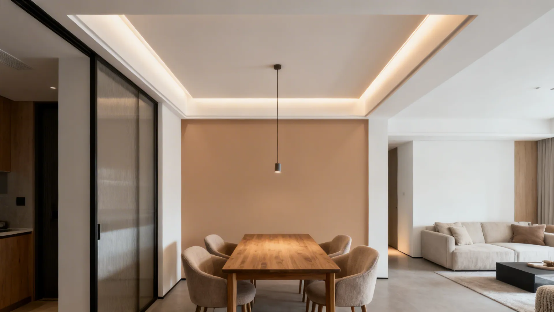 Dining area with a shallow clay-beige tray ceiling and a centered slim pendant in a compact loft.
