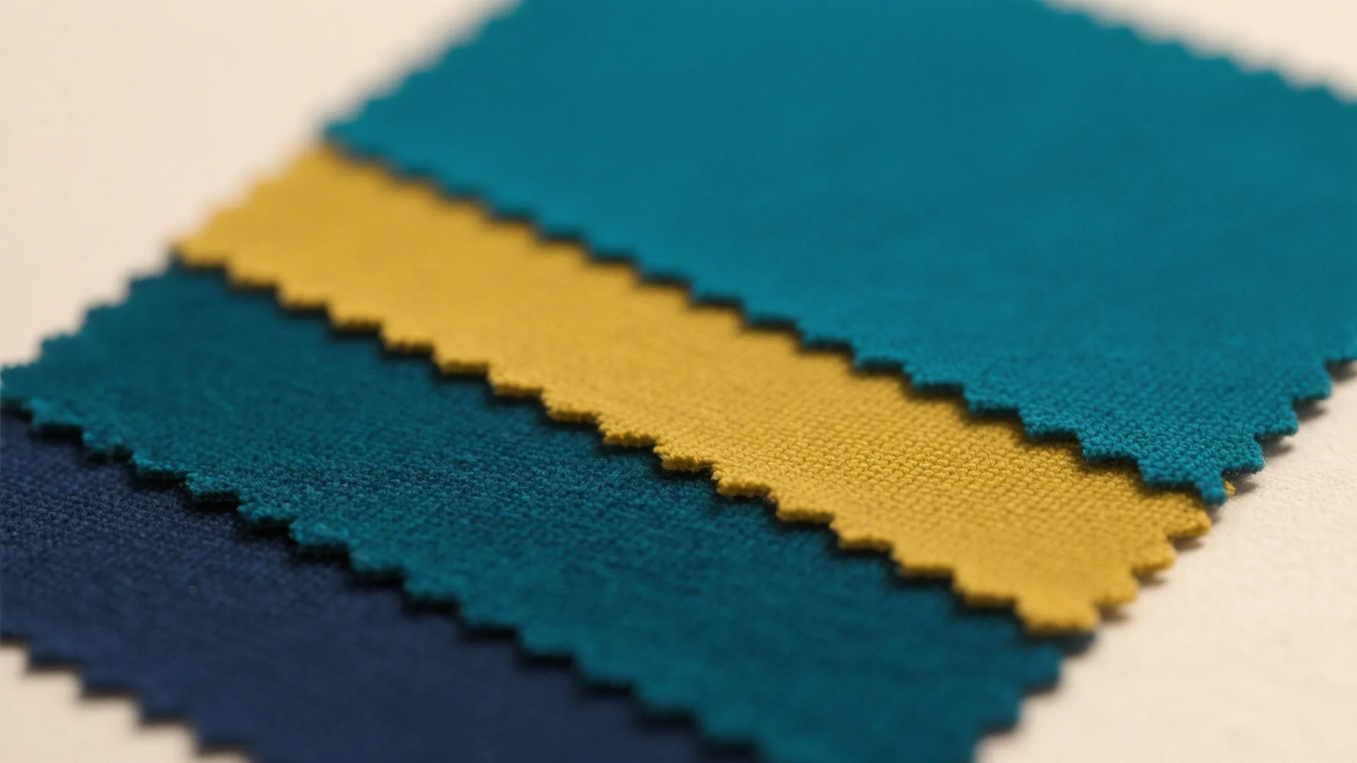 Close up of colorful fabric material samples showing blue and yellow textile texture for furniture