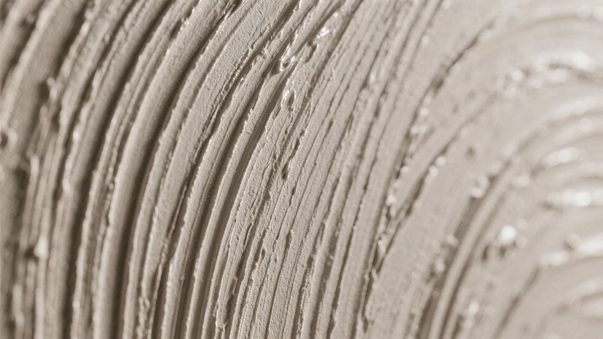 Close up view of grey wall paint with circular textured patterns for modern interior design