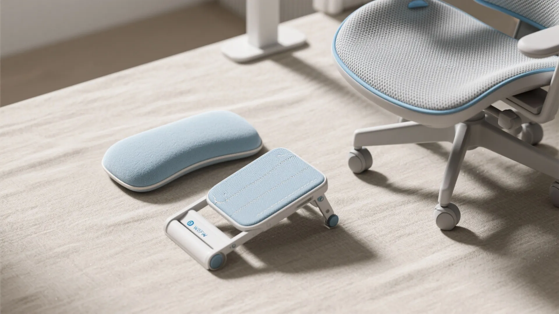 Blue office chair with matching wrist rest and adjustable footrest on a clean light desk