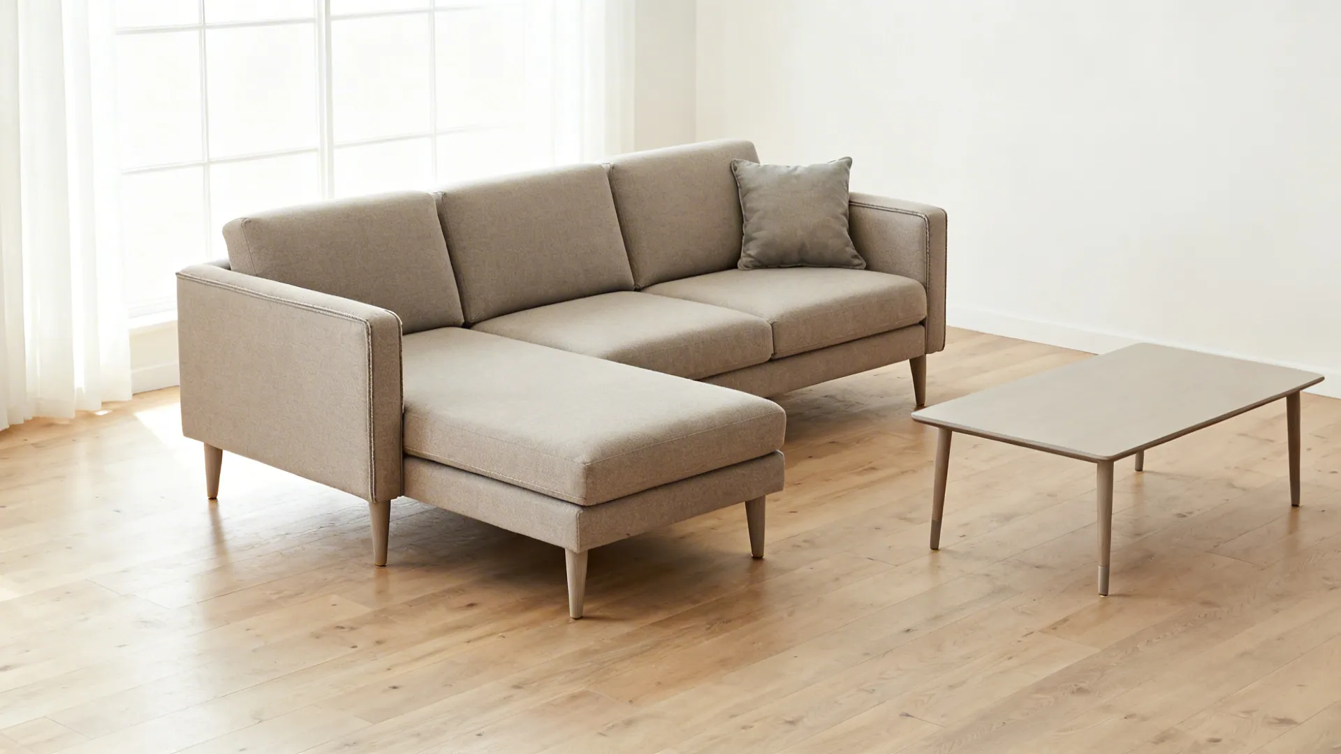 Compact chaise sectional with slender arms and raised legs in a small living room.