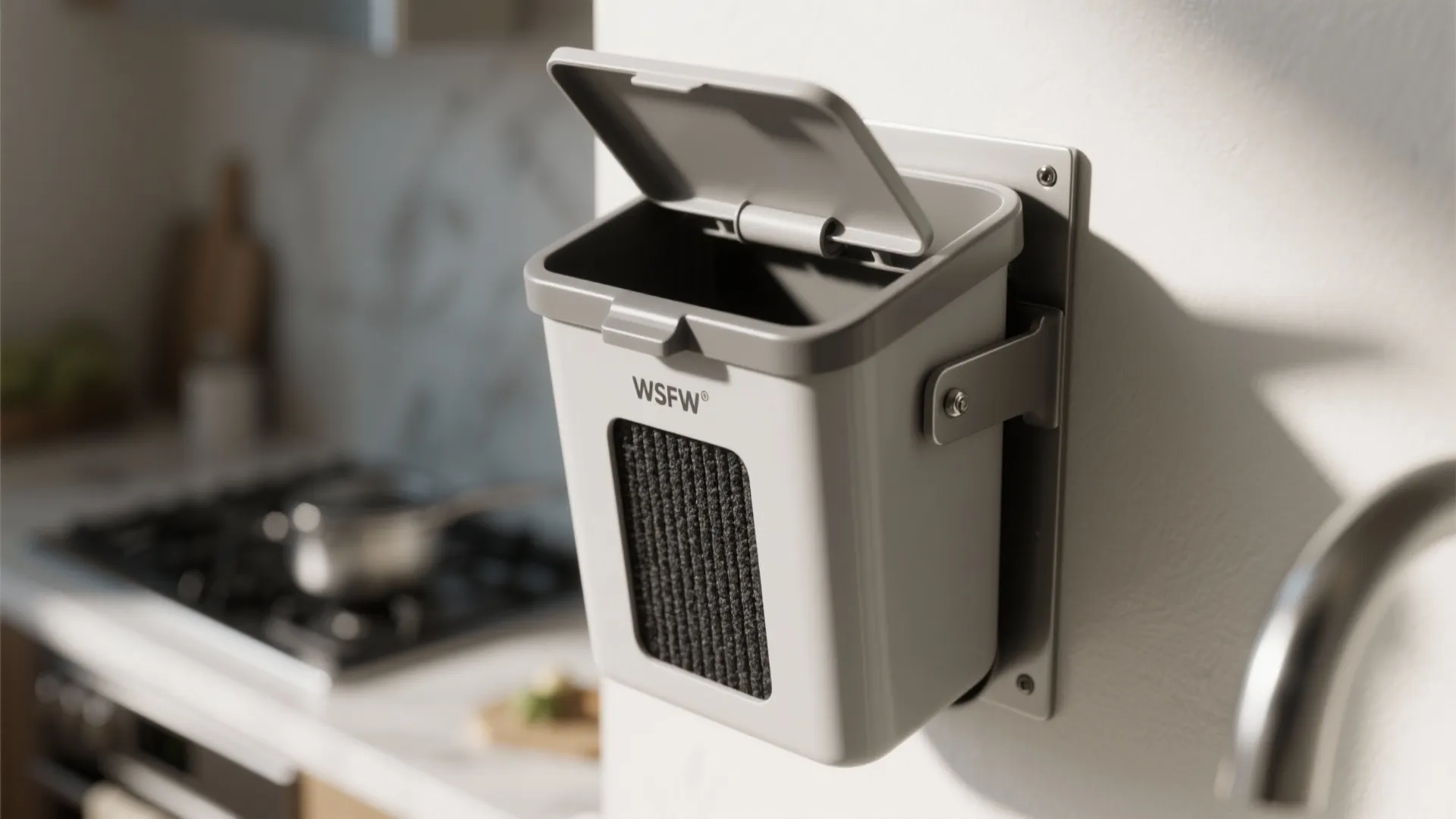 Close-up of a slim wall-mounted compost caddy showing charcoal filter, lid seal, and mounting hardware near a prep area.