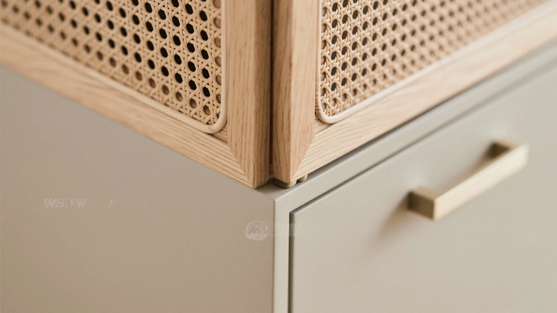 Close up view of a grey cabinet drawer with a gold handle and woven texture
