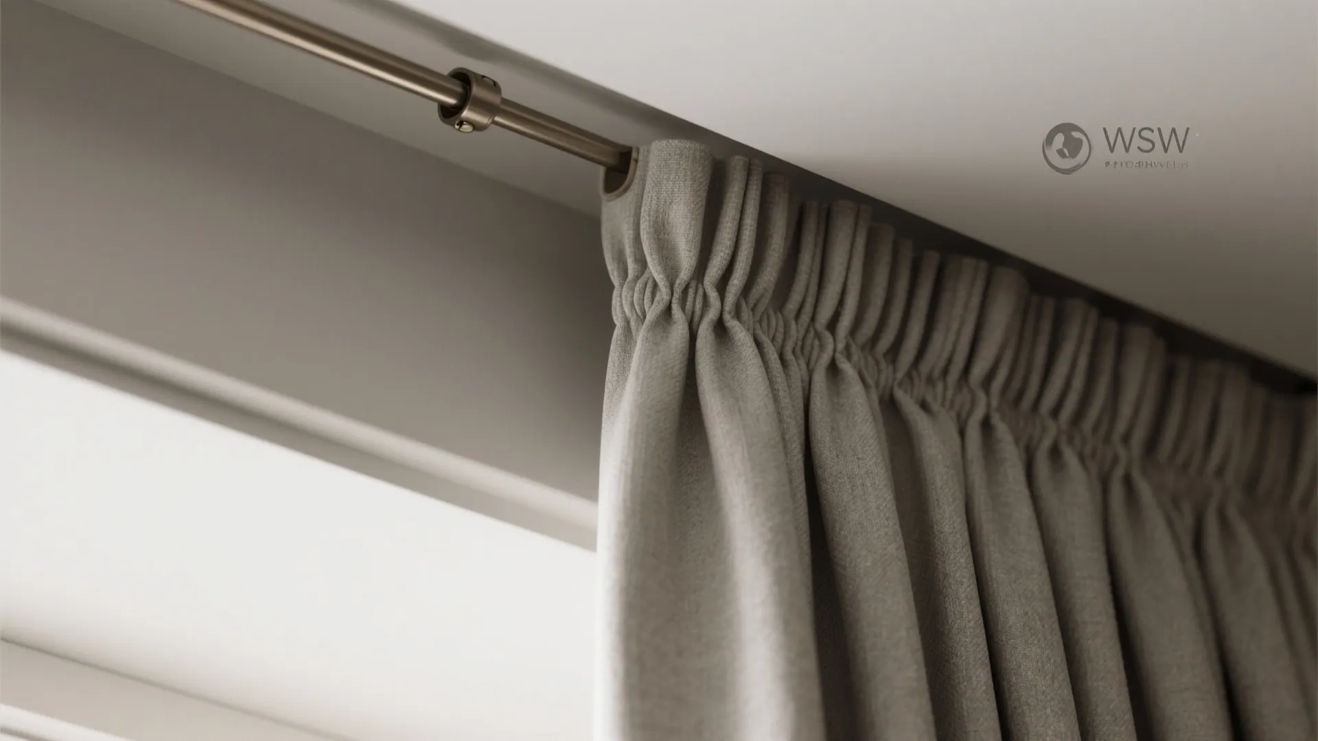 Macro view of ripple fold curtains emerging from a recessed concealed ceiling track with precise carriers and tailored stitching