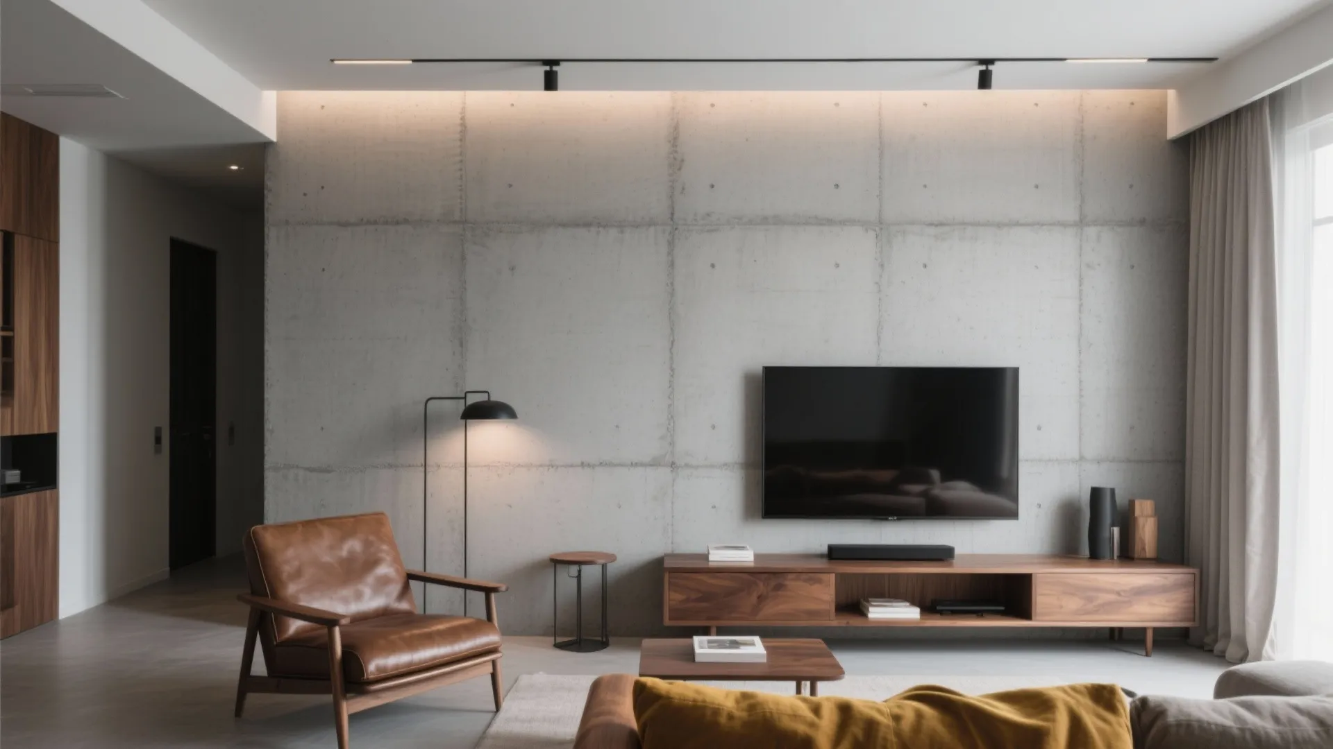 Modern living room with concrete wall, television, wooden cabinet, brown leather chair, and floor lamp