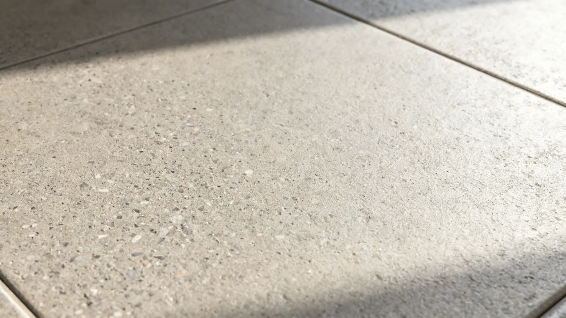 Macro of matte concrete-look porcelain revealing fine texture and tonal variation.