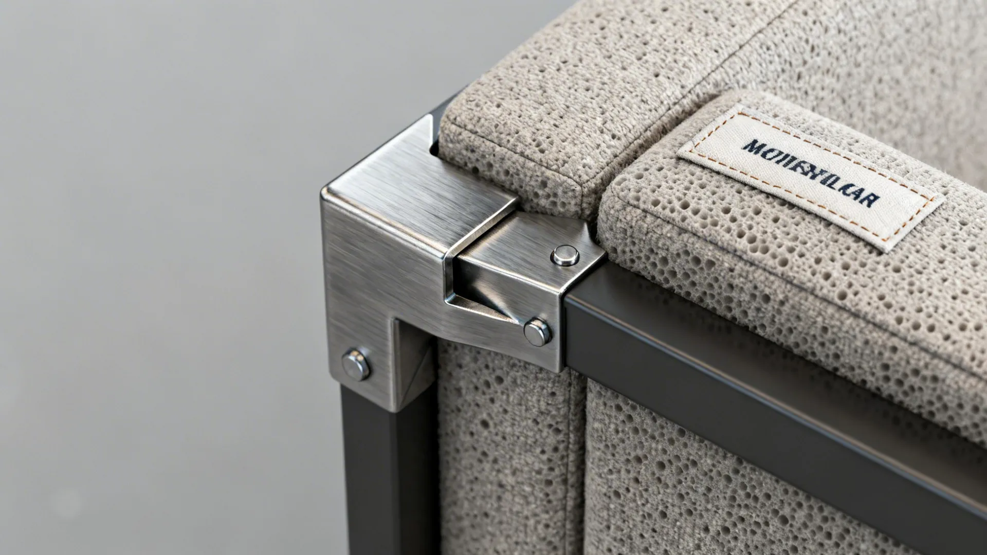Close-up of modular sofa connector, zipper for removable cover, and foam texture.