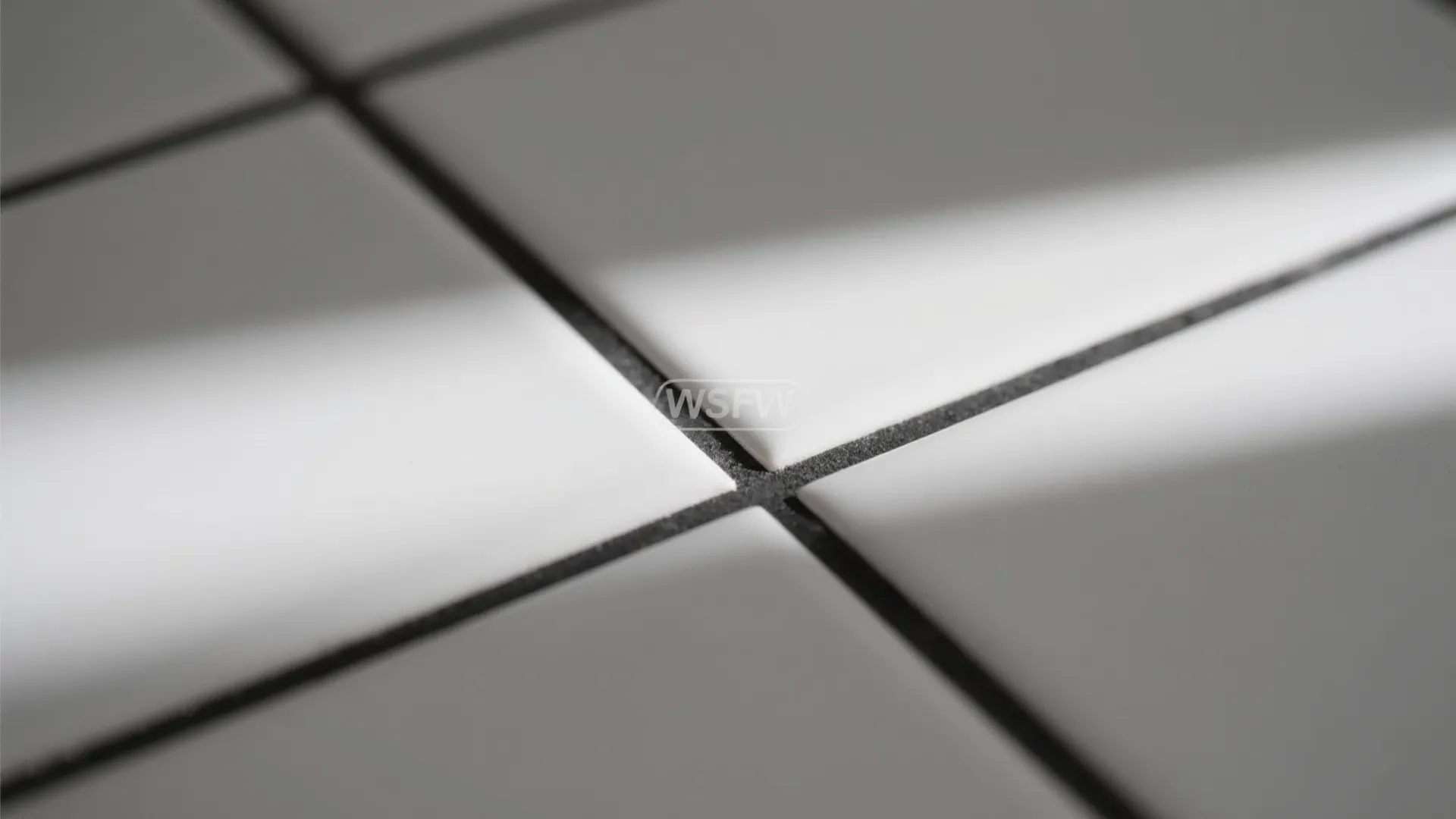 Macro of soft-white 2x4 tiles with charcoal grout showing crisp geometry and subtle glaze texture.