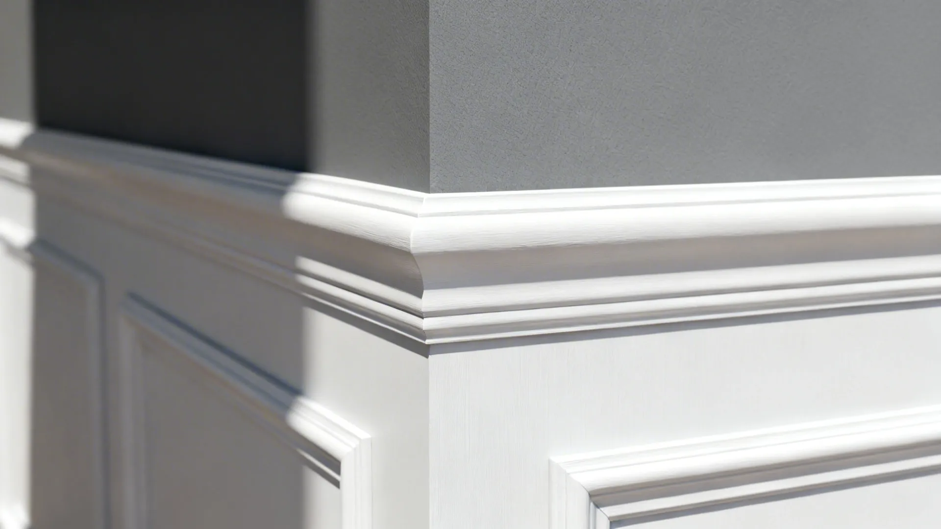 Close-up of bright white trim creating a sharp contrast with grey wall