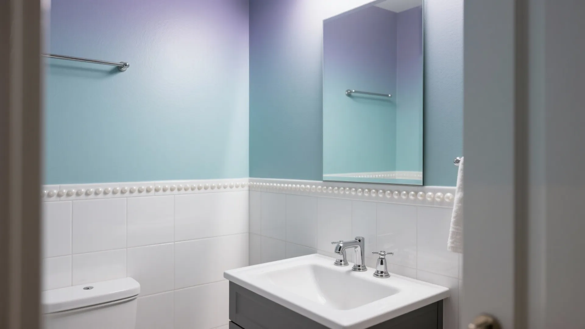 Small bathroom featuring purple and blue gradient walls with white square tiles and vanity sink