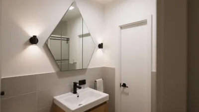 Modern Bathroom Design with Geometric Mirror & Warm Wood Accents
