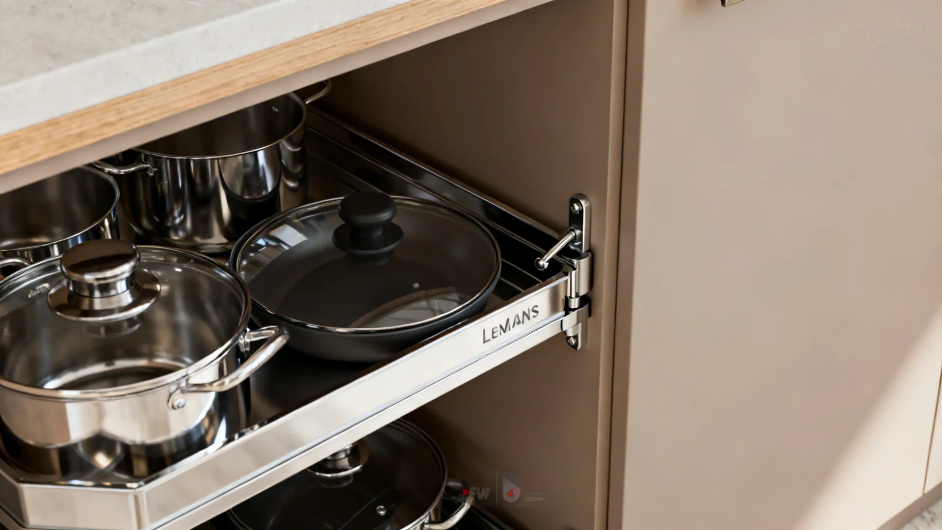 Macro of a chrome LeMans corner carousel neatly organizing pots inside a base cabinet.