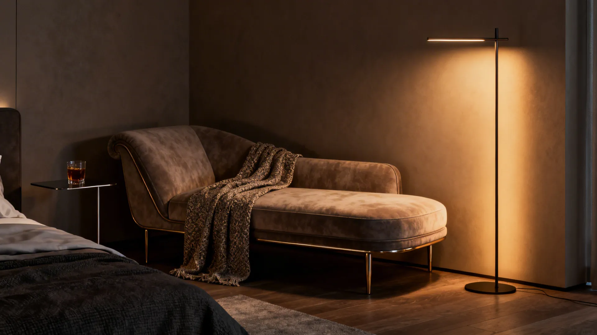 Corner chaise in a master bedroom with a floor lamp and side table, warm accent lighting.