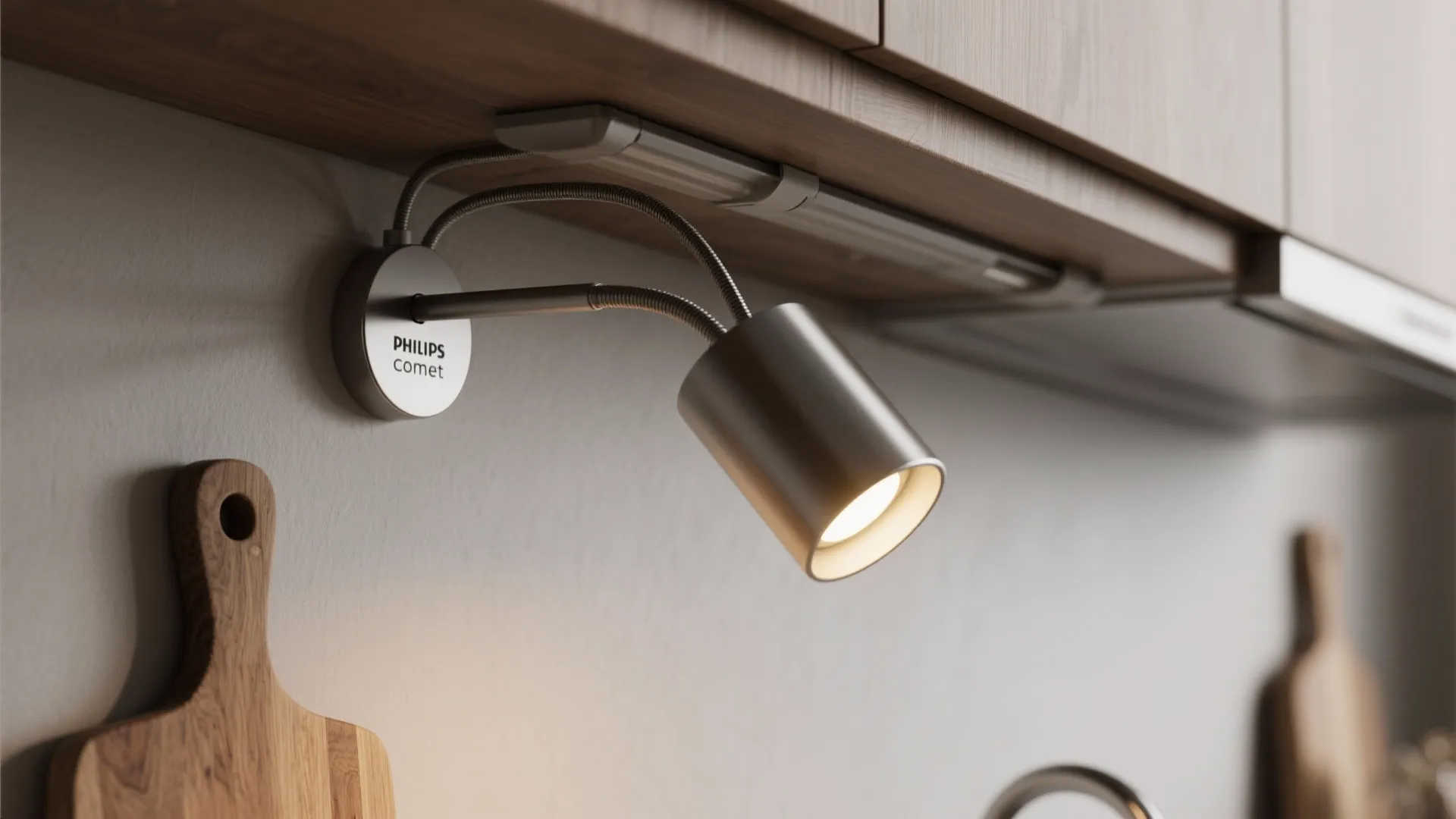 Macro of Comet swing arm and magnetic cable guide illuminating a corner chopping board.