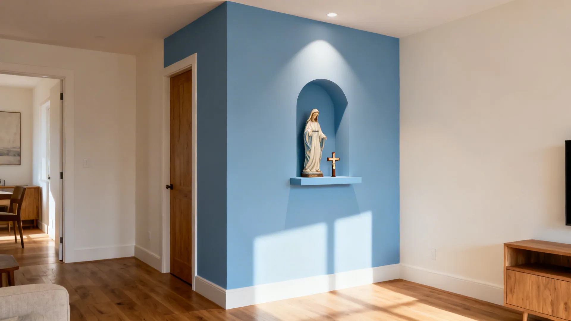 Corner niche in soft Marian blue with a small statue and crucifix under warm light.