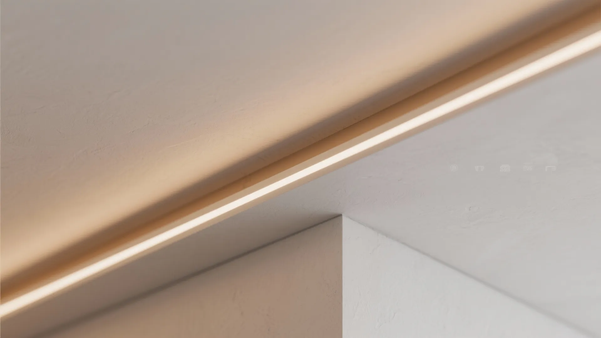 Close up of warm hidden light fixture installed along a white wall and ceiling corner