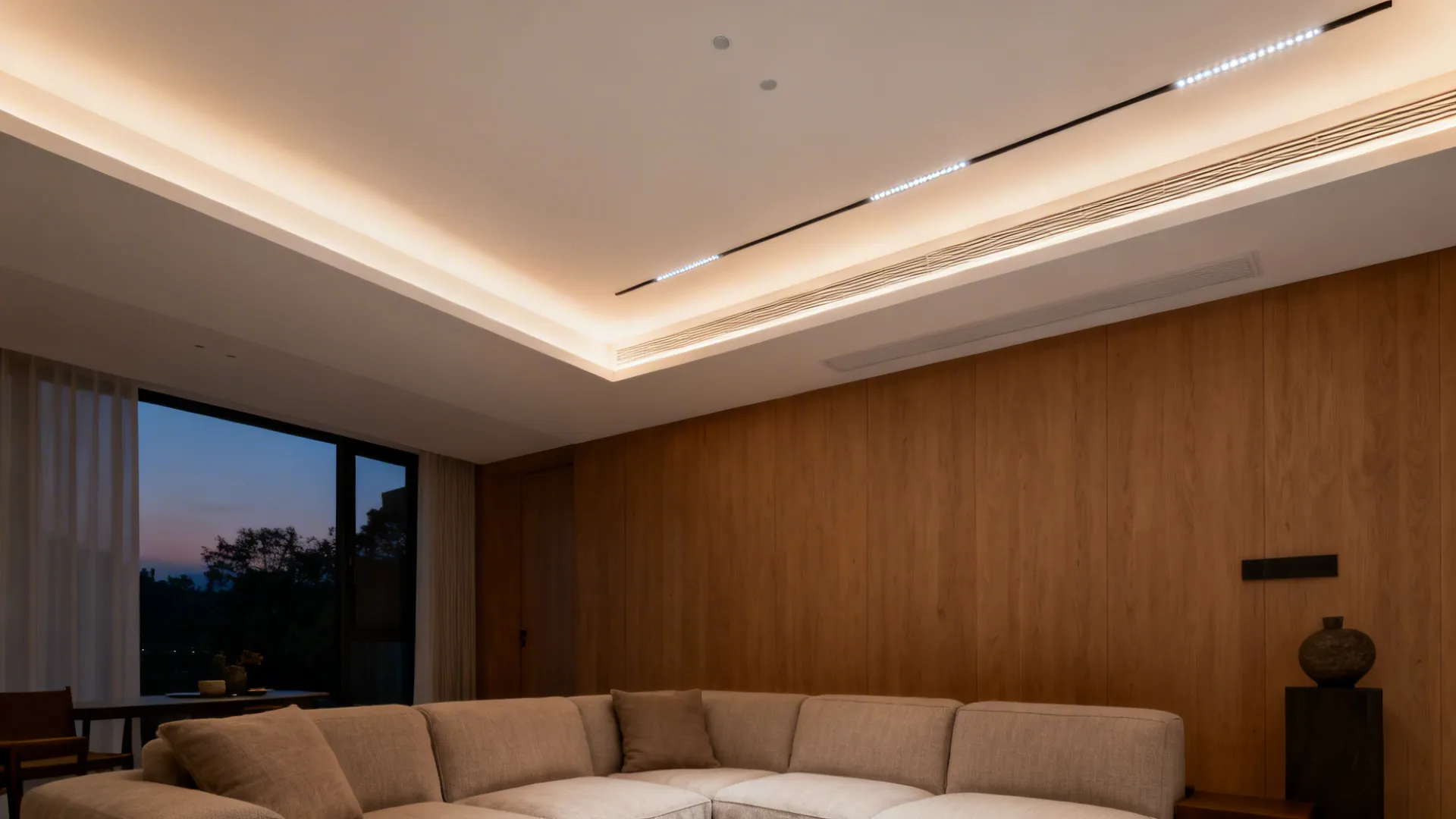 Warm indirect cove lighting makes a low living room ceiling feel higher and calmer.