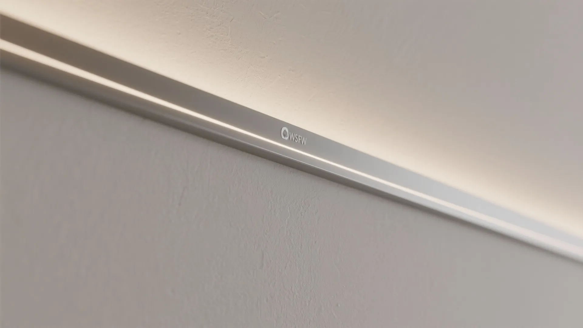 Macro detail of a recessed cove with concealed LED strip grazing a satin wall.