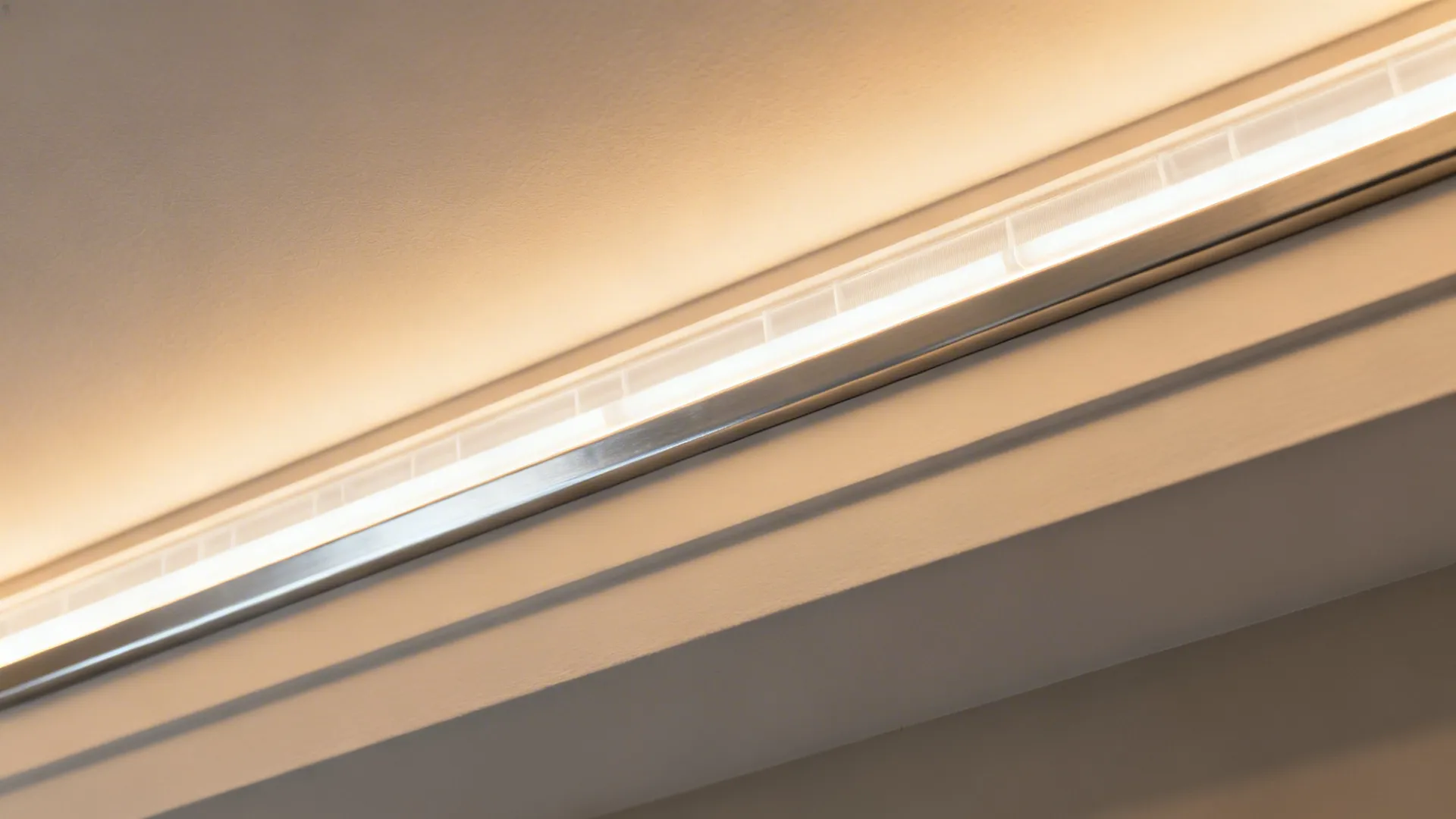 Close up of warm led light strip hidden inside white ceiling or wall panel groove