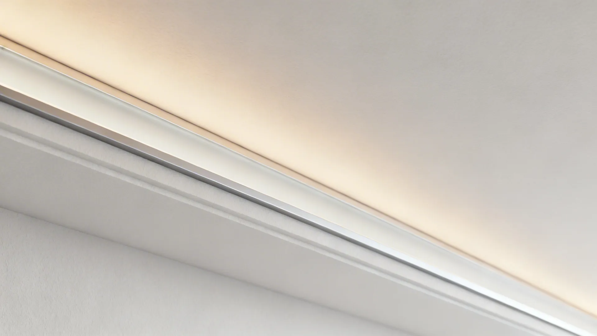 Macro of a crisp floating ceiling reveal with a diffused LED cove channel and seamless finish.