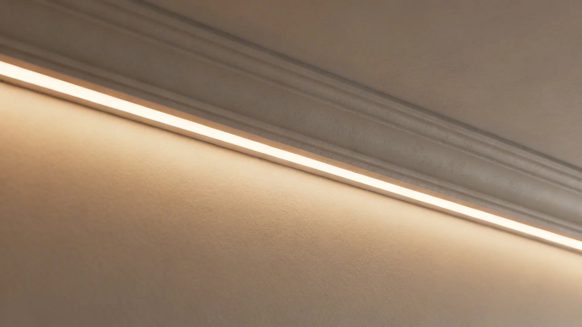 Close-up of warm cove LED strip creating a soft indirect glow along a ceiling recess.