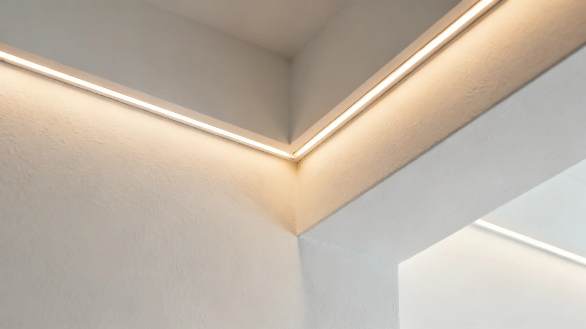 Close-up of a shallow ceiling cove with a smooth warm LED wash and crisp paint lines.