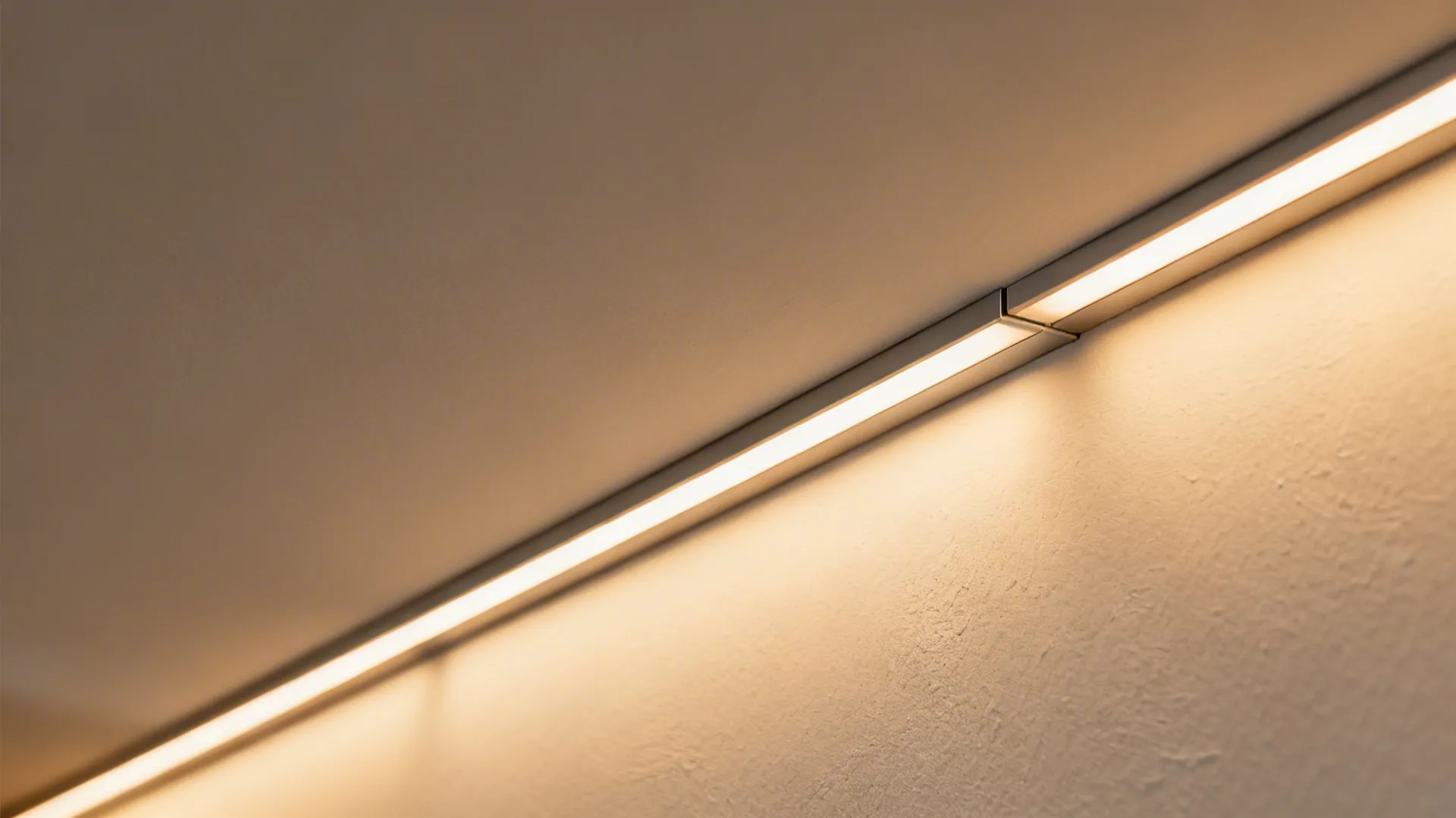 Macro view of cove ceiling reveal with aligned LED profile and smooth gypsum finish.