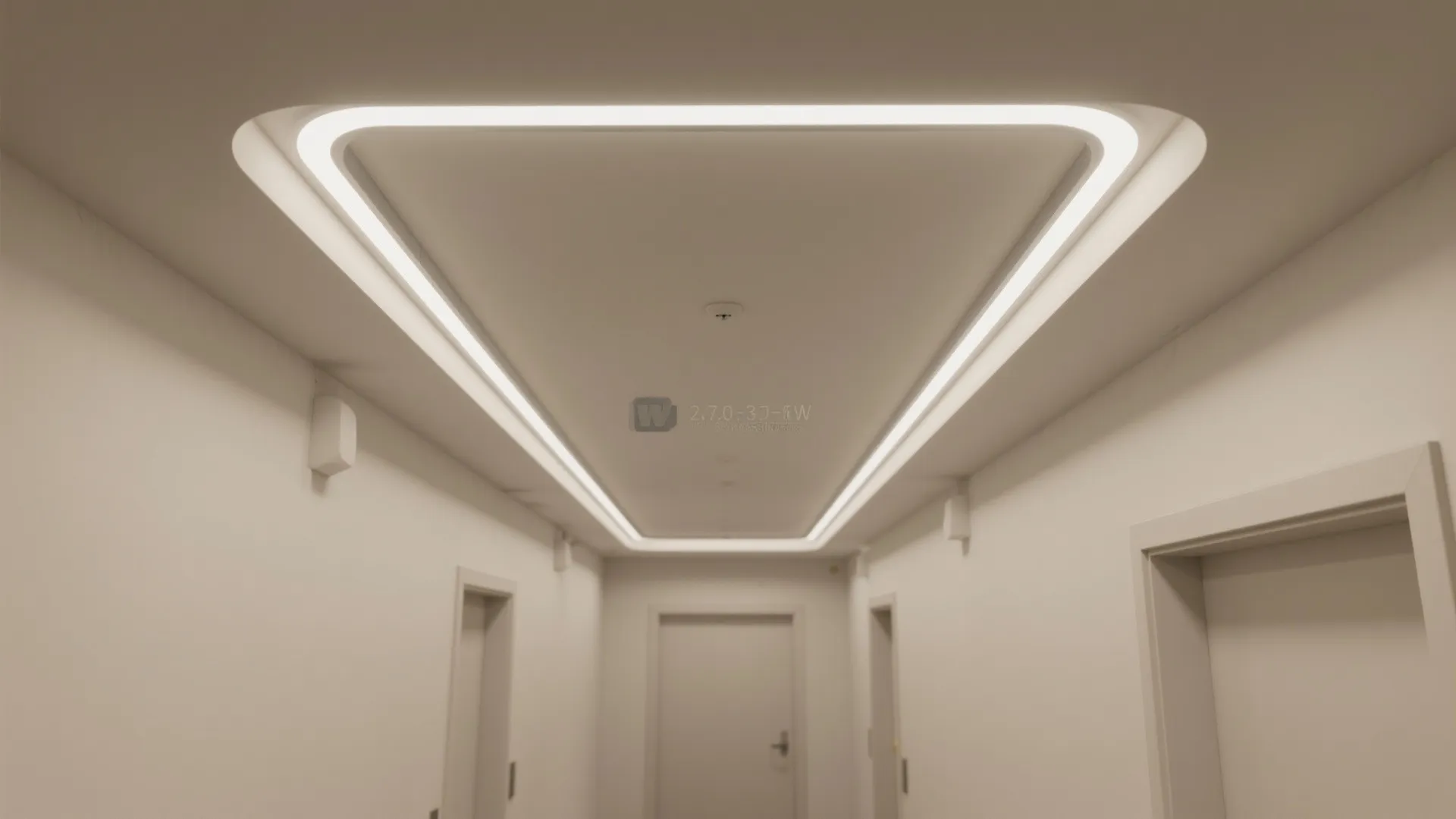 White hallway ceiling with a large recessed light fixture forming a long thin rectangular shape