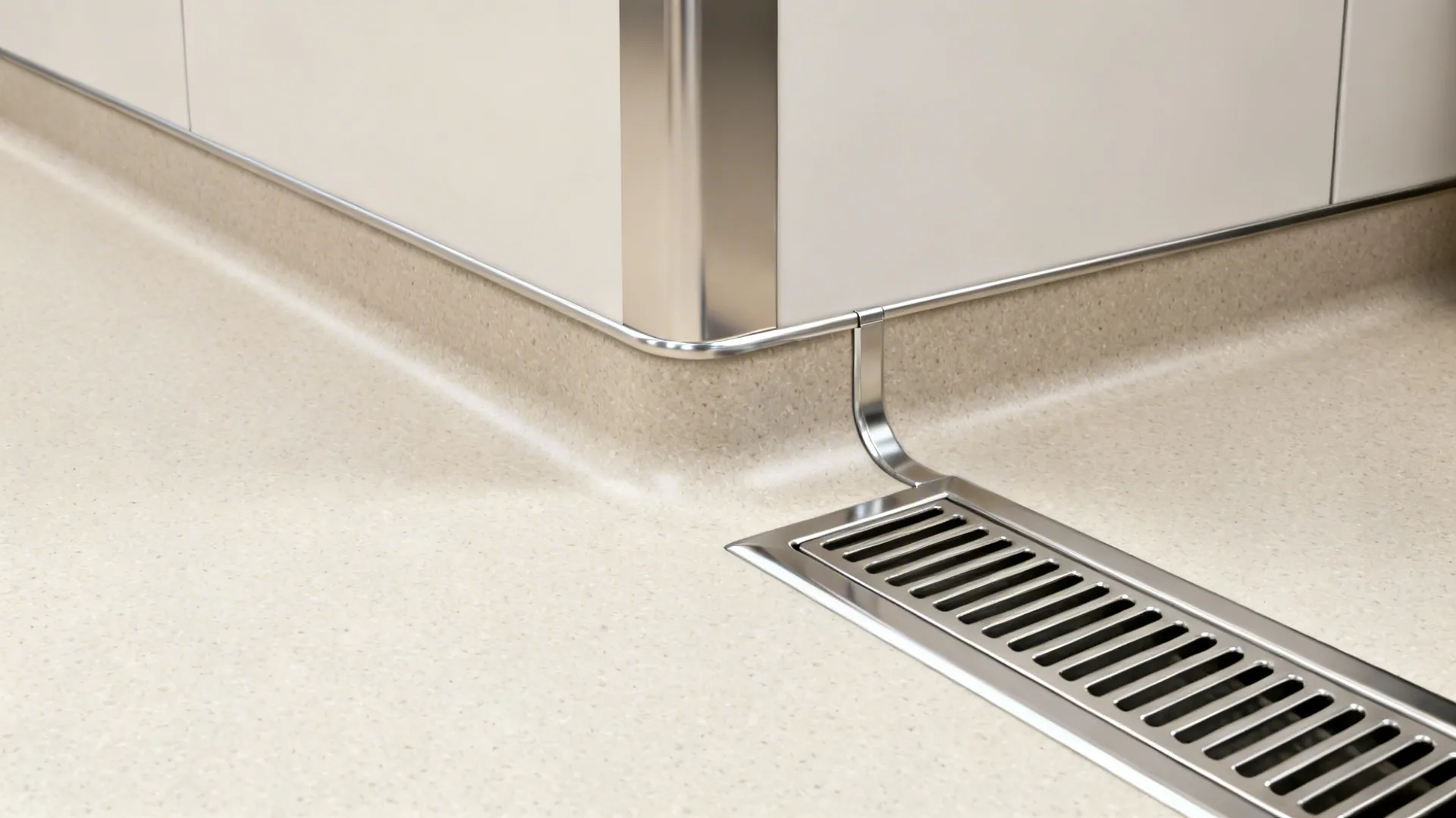 Close-up of 4-inch coved epoxy floor transitioning to a stainless trench drain with solids grate.