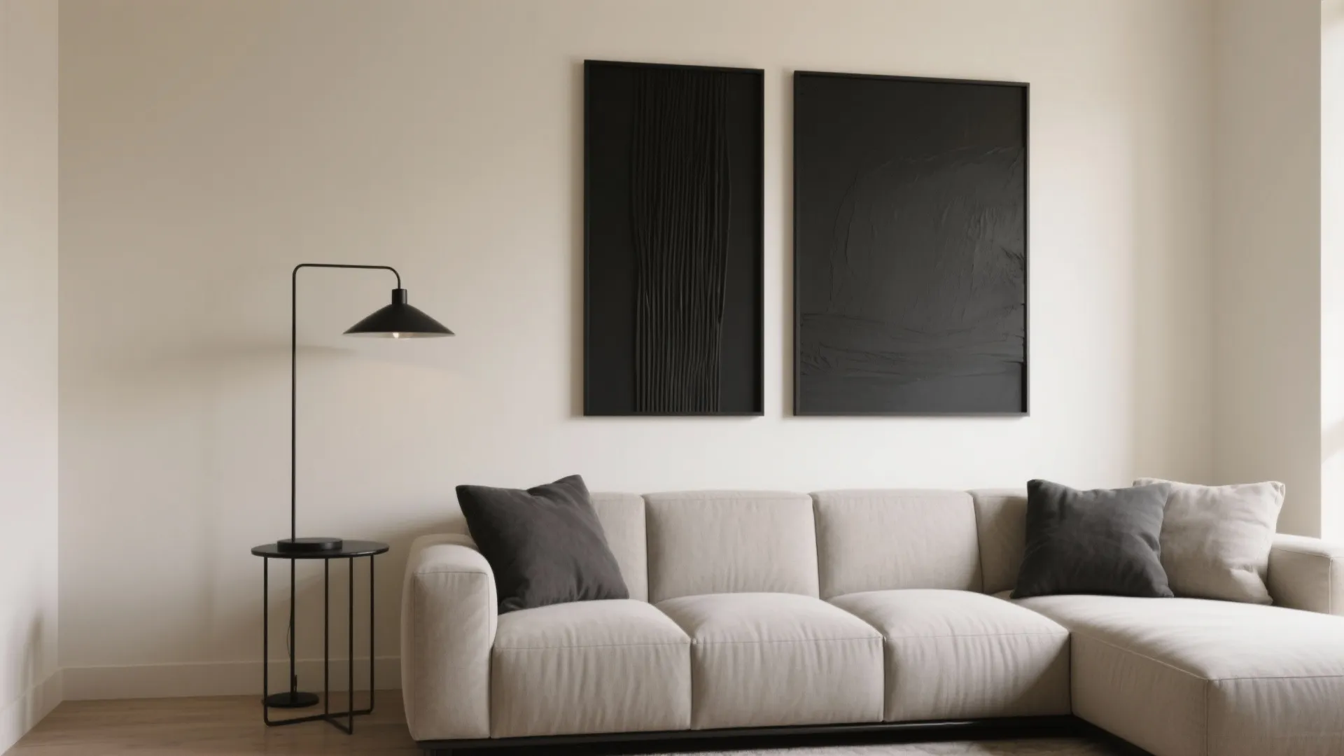 Contemporary living room with a beige sofa black wall lights and two large black art pieces