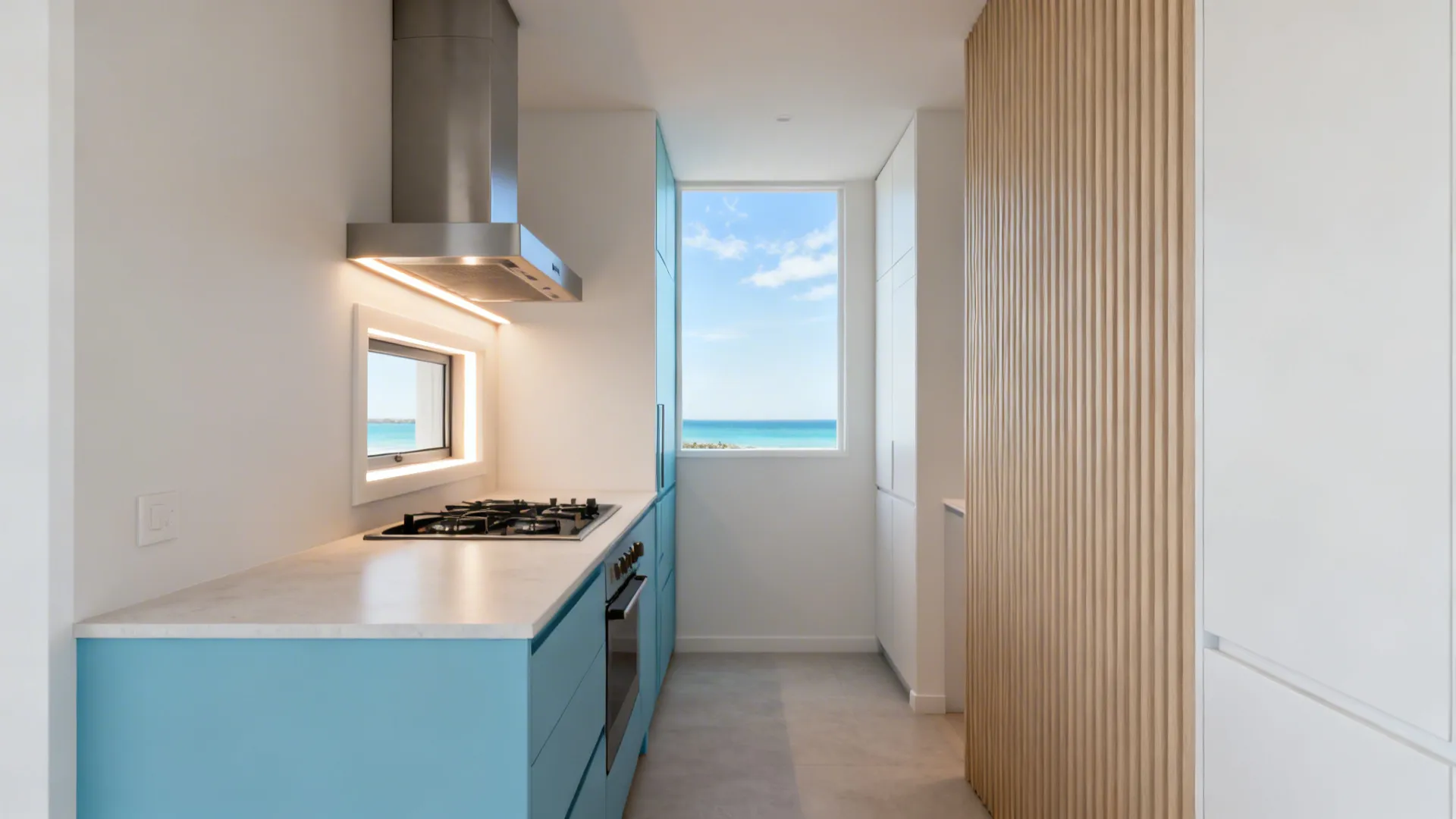 Compact coastal kitchen with ducted hood and highlight window enabling cross-ventilation.