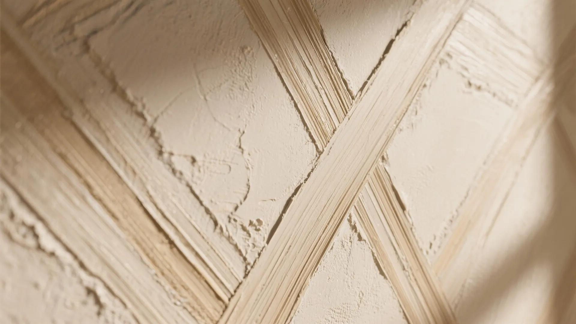 Close up of cream wall panel texture with textured brush strokes in a cross pattern