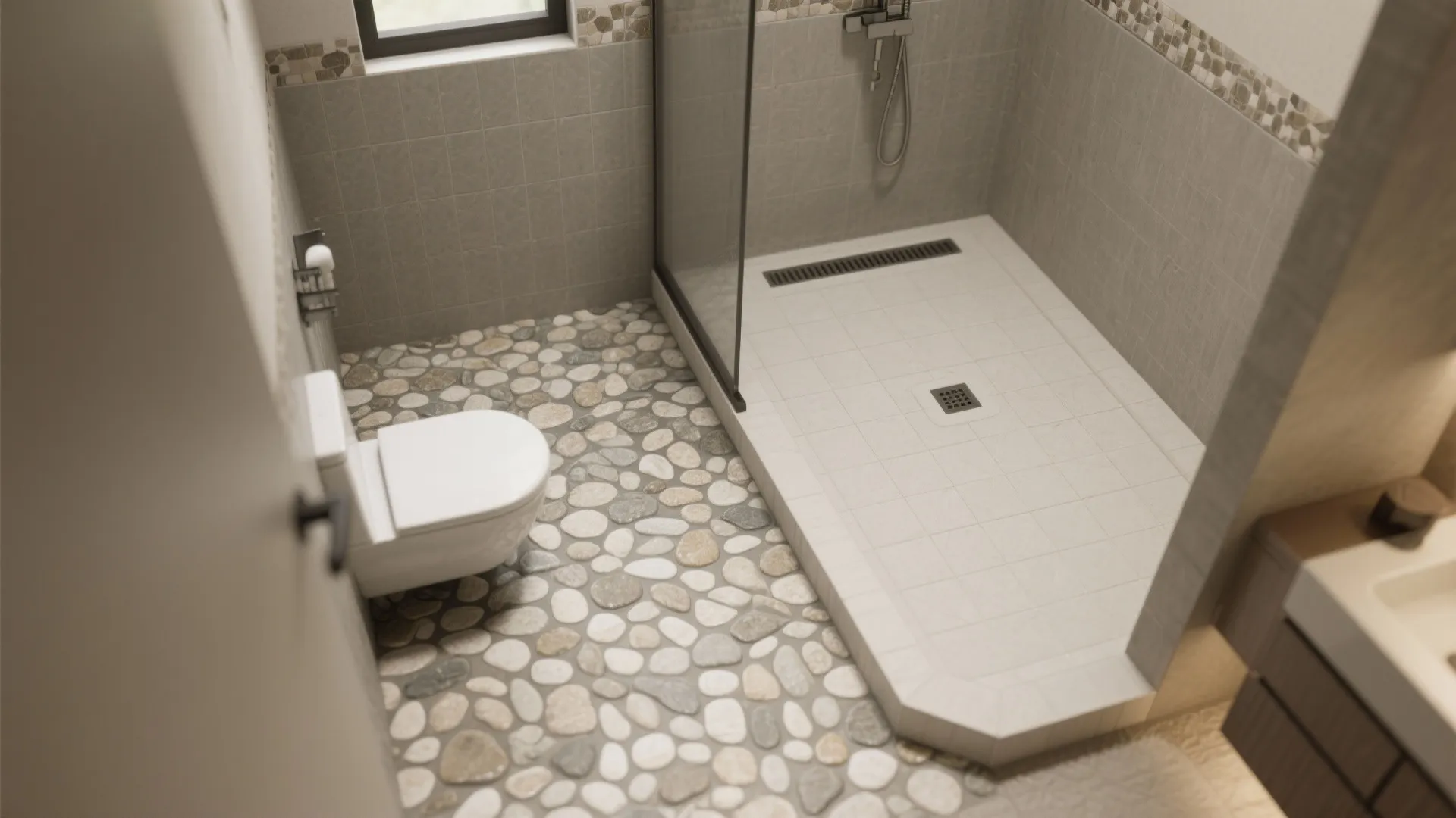 Top-down view of a pebble shower floor with linear drain and gentle slope.