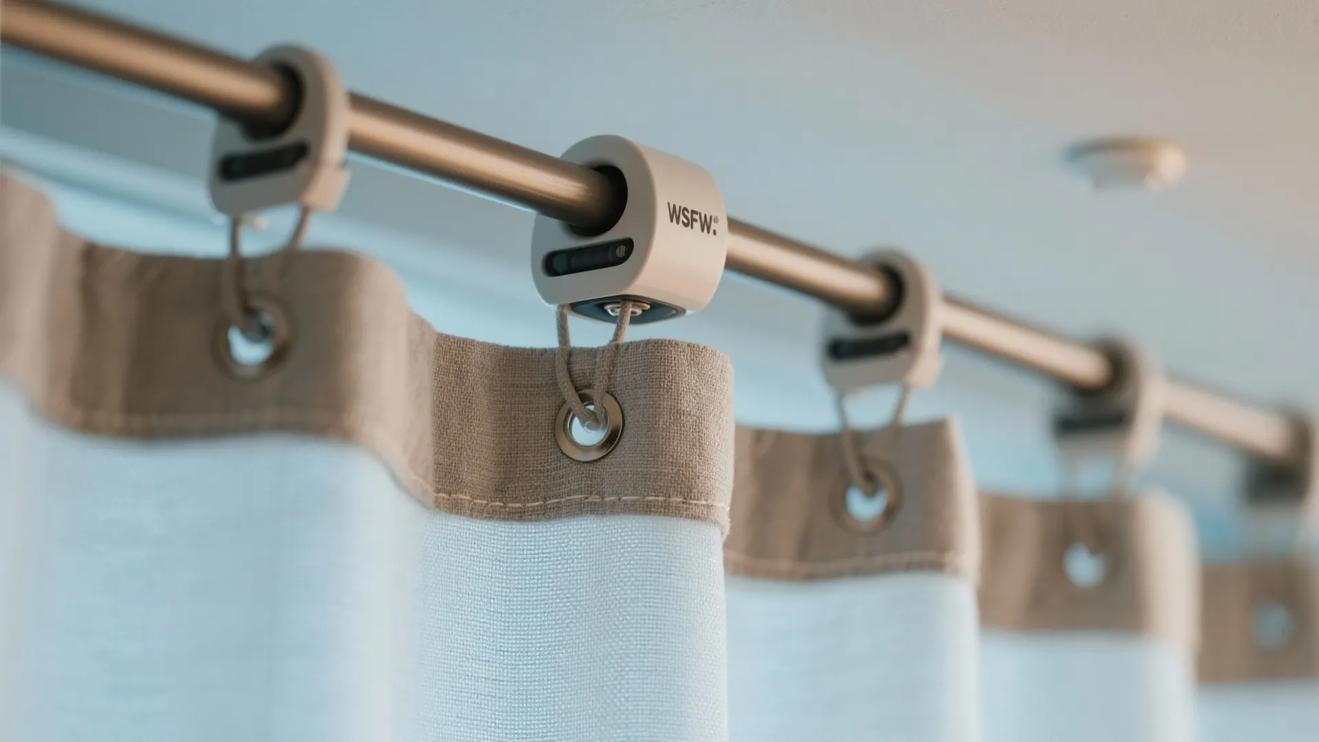 Macro of curved ceiling curtain track with waterproof fabric and weighted hem.