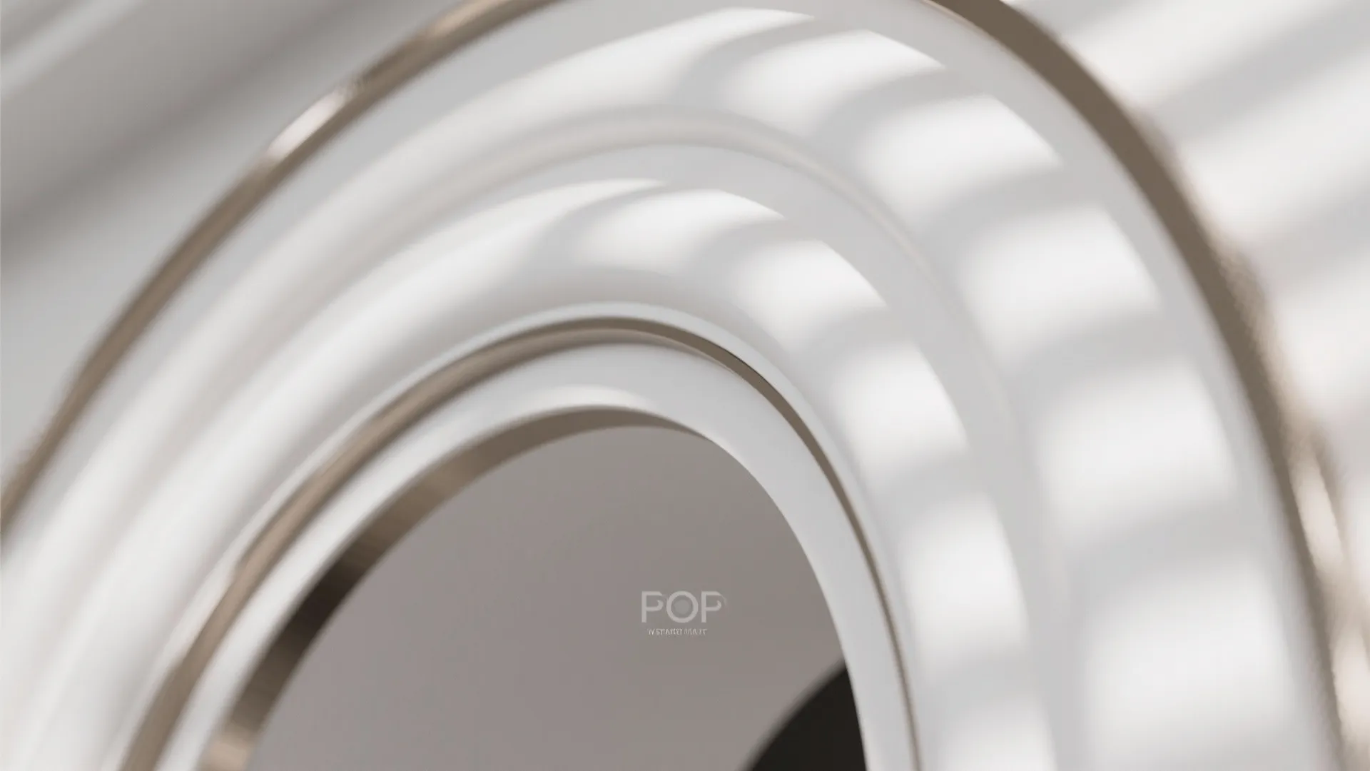 Close up view of white curved wall panel design with warm light and metallic trim
