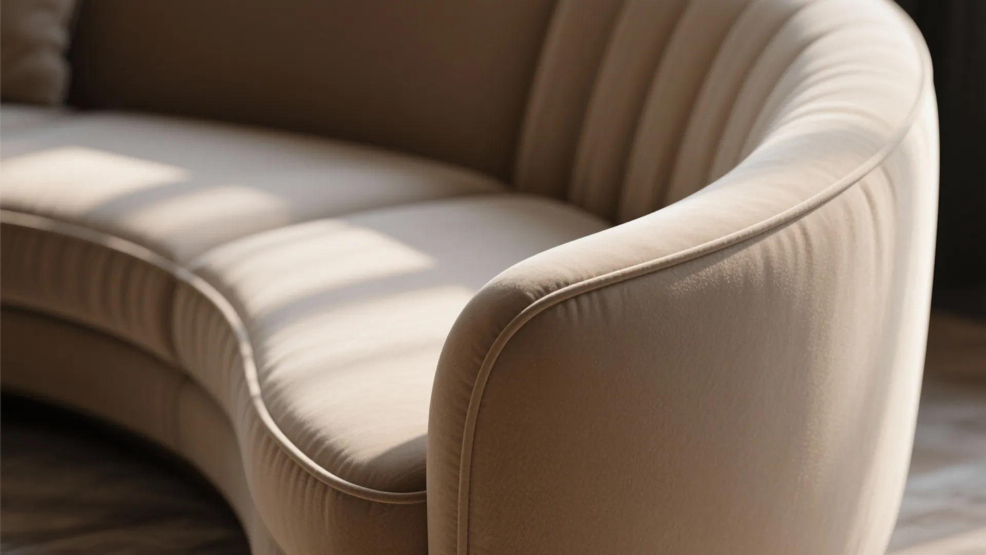 Close up detail of curved beige sofa fabric with vertical lines and sunlight in room