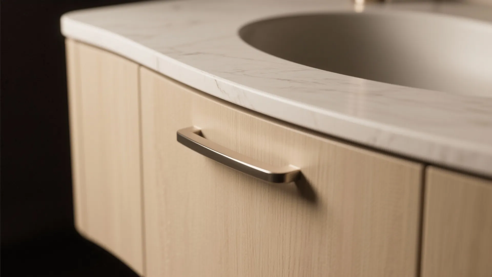 Close-up of a curved-edge vanity panel and countertop, showcasing smooth rounded design.