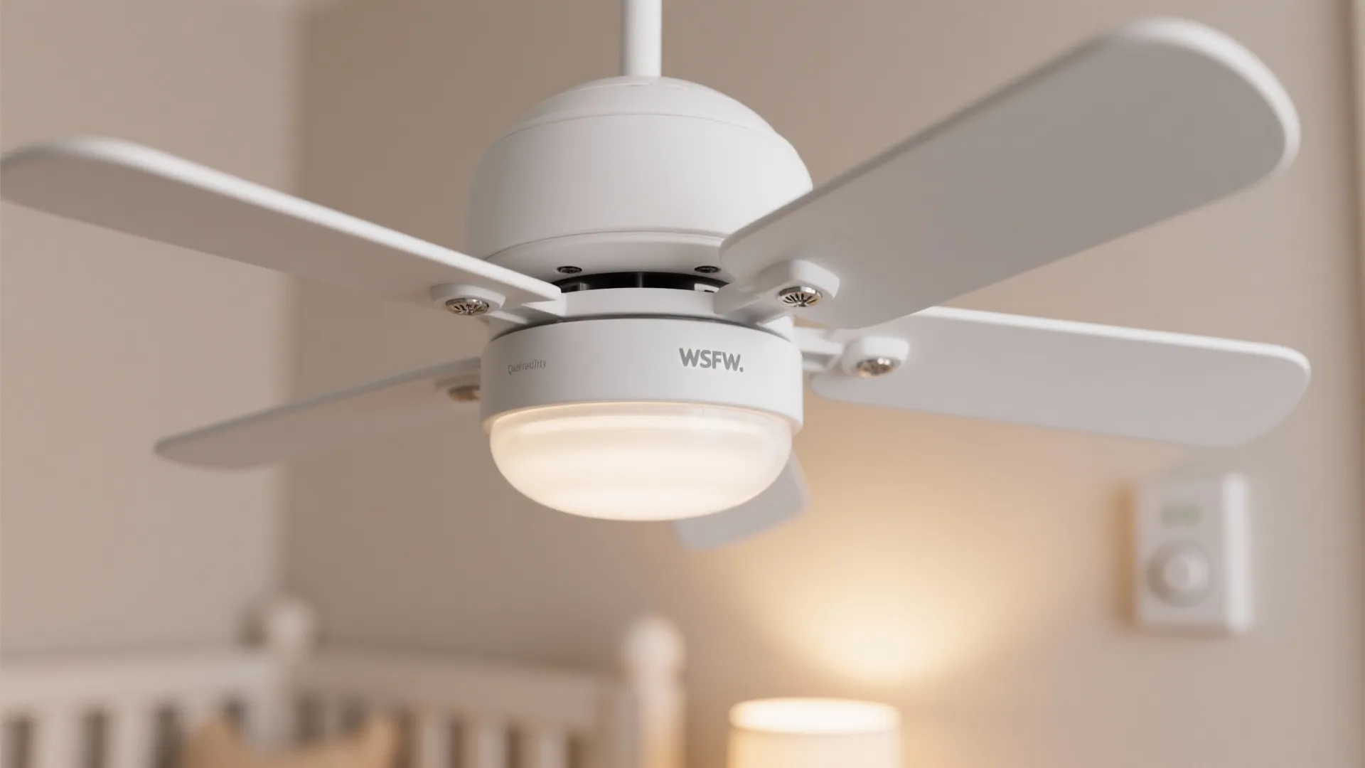 Close up view of a white ceiling light fan with four blades in a bedroom