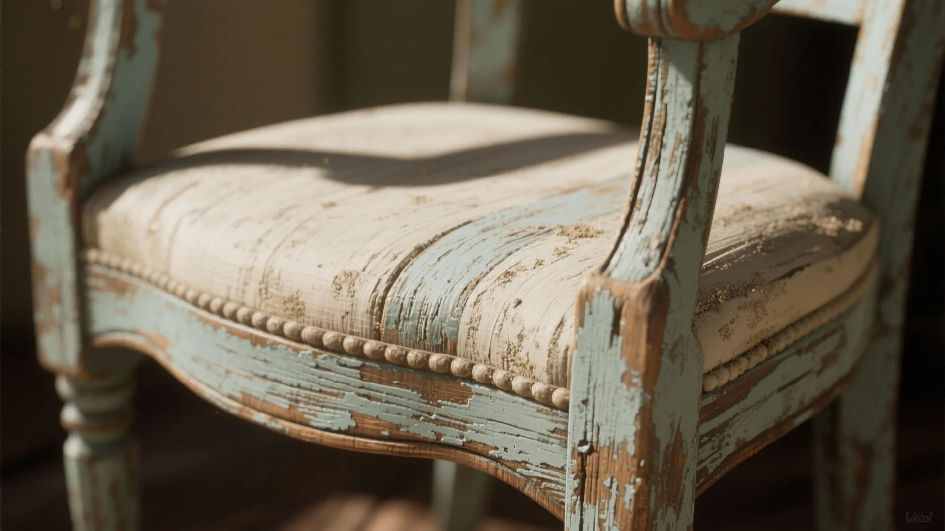 Vintage wooden chair with peeling light blue paint showing weathered texture and aged furniture style details