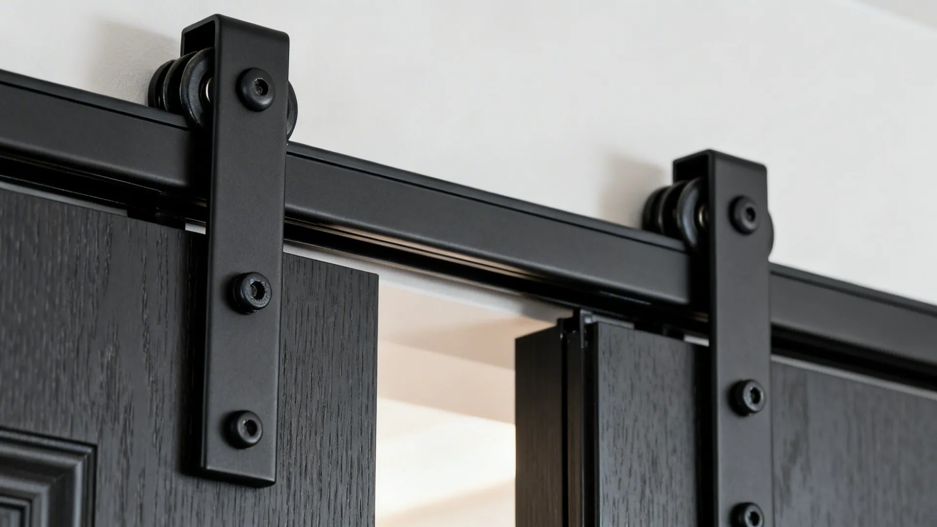 Macro view of double ceiling tracks and floor guide for sliding door panels.
