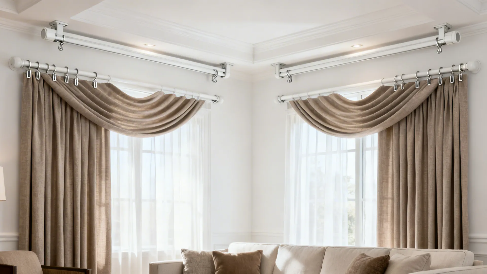 Corner room with two windows having brown curtains and decorative fabric hung from white ceiling tracks