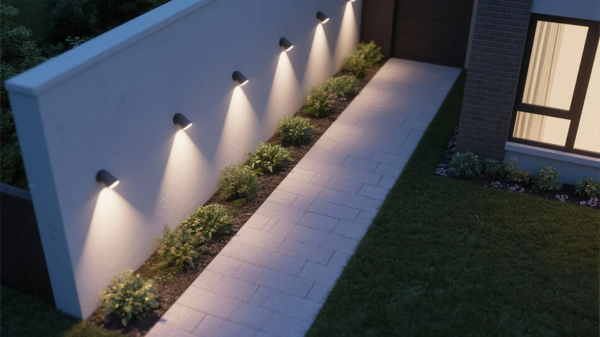 Top view of a garden path with wall light fixtures shining on plants and white pavement