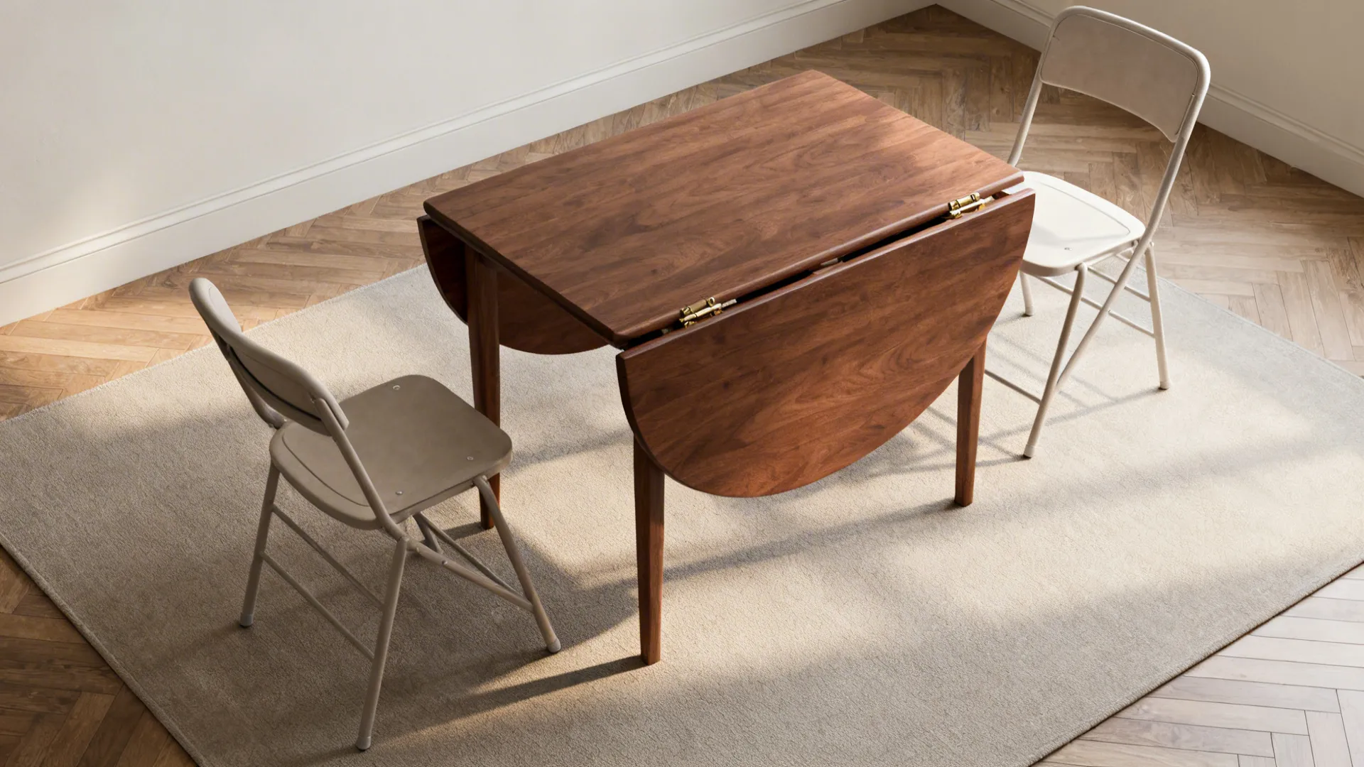 Top-down view of a walnut drop-leaf table partly extended with stackable chairs in a small studio layout.